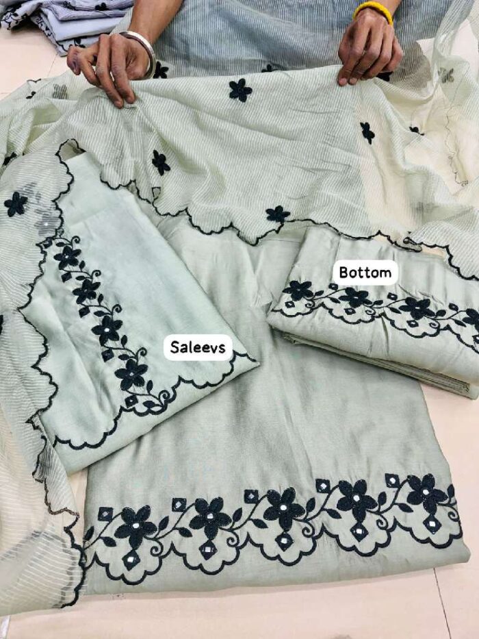 Mint green muslin embroidery suit with black floral border and dupatta